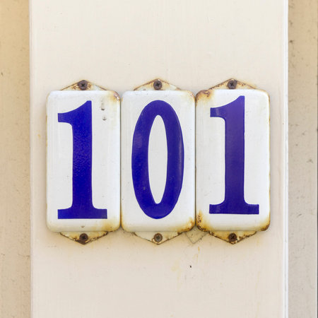 Enameled house number one hundred and one on three separate plates.