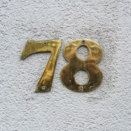 reflective brass house number seventy eightの写真素材
