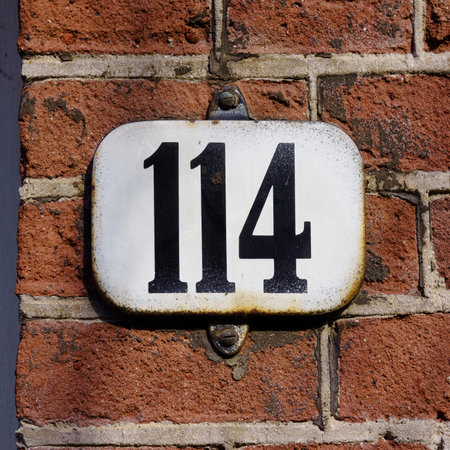 Enameled house number one hundred and fourteen.