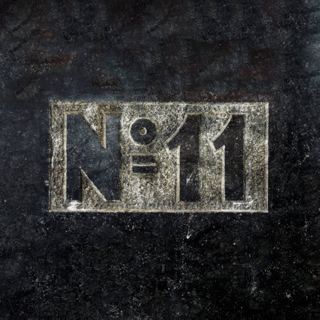 House number eleven carved in black marble