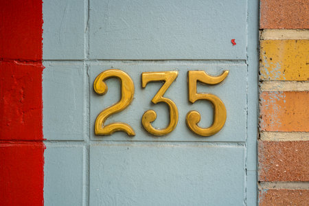 polished bronze house number two hundred and thirty five.の写真素材