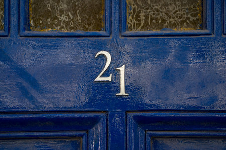 house number twenty one on a blue painted doorの写真素材