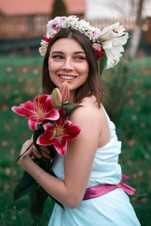 A young girl smiling in the garden in springの写真素材