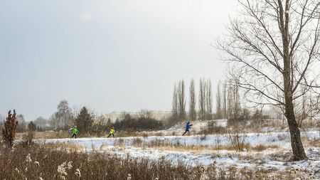 Fit family - man, woman and child - training cross-country skiing in the snowy city park. 06.01.2017, Gdansk, Poland.のeditorial素材