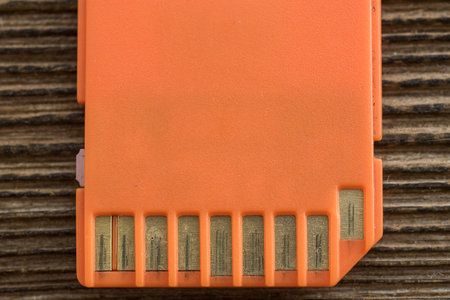 Orange memory SD card, ogd wood background.