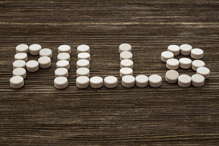 Medical pill on wooden table. Close up photo.