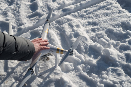 White drone quad copter with flying in the blue sky.の写真素材