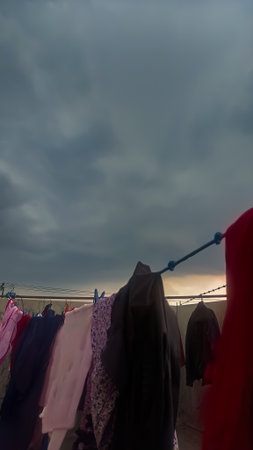 clothes drying on a clothesline against a stormy sky.