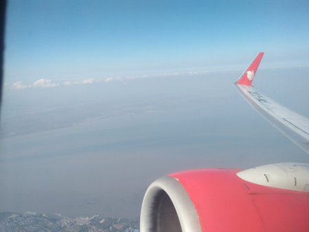 View from airplane window on wing and wing of airplane in the sky