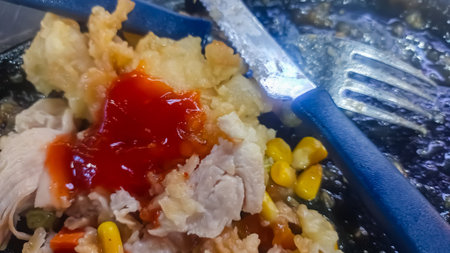Fried chicken fillet with sweet and sour sauce in a pan