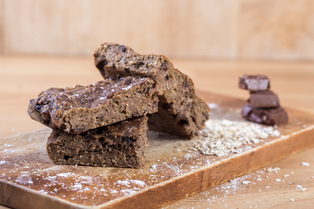 Oats brownies with measuring spoon on the wooden tableの写真素材