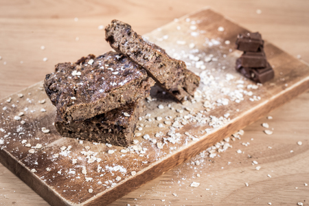 Oats brownies with measuring spoon on the wooden tableの写真素材