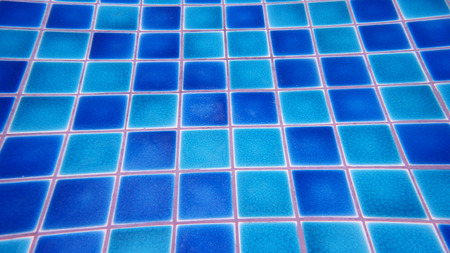 Blue mosaic tiles on the ground of swimming poolの写真素材