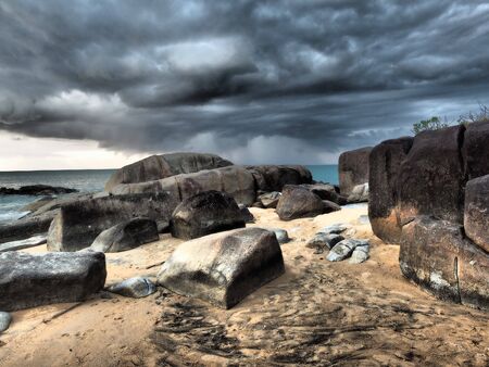Sun breaking through the stormclouds before rain.の写真素材