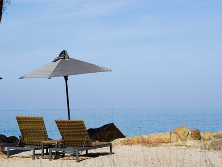 Summer Travel Vacation and Holiday concept  Beach chairs and umbrella on wooden desk against blue...