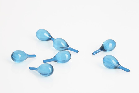 hair vitamin serum capsule blue color in container on white backgroundの写真素材