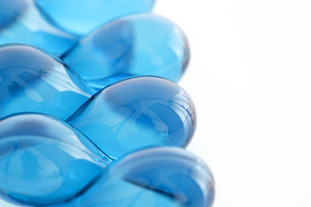 hair vitamin serum capsule blue color in container on white backgroundの写真素材
