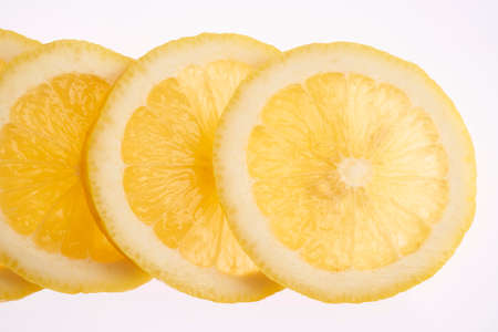 Fresh lemon slices isolated on white backgroundの写真素材