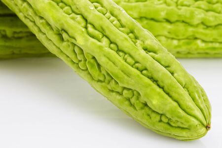 Close up bitter gourd slices on white backgroundの写真素材