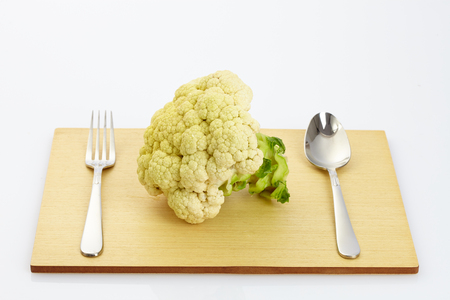 fresh cauliflower on wooden table in white backgroundの写真素材