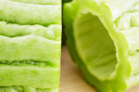Bitter gourd slices on wooden in white backgroundの写真素材