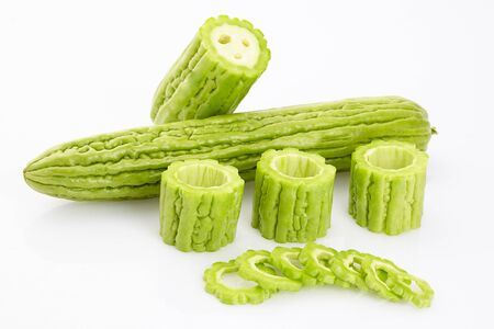 Close up bitter gourd slices on white backgroundの写真素材