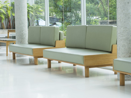 wooden chair with green pillow in living roomの写真素材