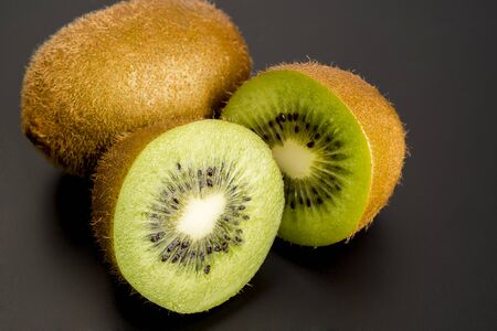 Close up Kiwi fruit cut in studio on wood.の写真素材