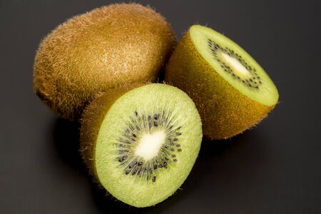 Close up Kiwi fruit cut in studio on wood.の写真素材