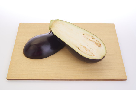 Cutting eggplants on wooden cutting board before cookingの写真素材
