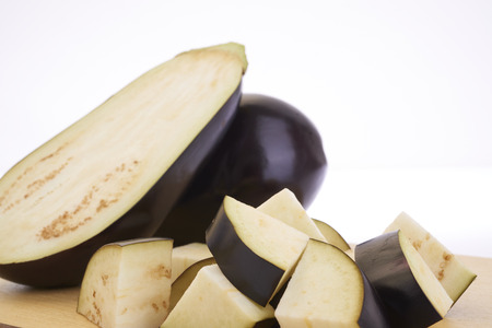 Cutting eggplants on wooden cutting board before cookingの写真素材