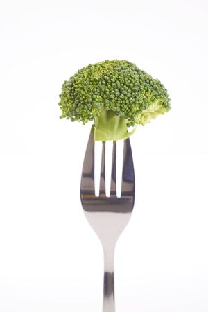 Broccoli on a fork isolated on a white background.の写真素材