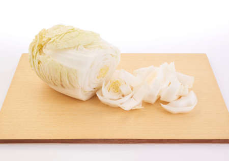 shooting fresh white cabbage on cutting boardの写真素材