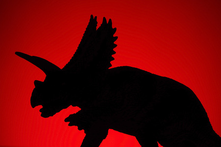 shooting dinosaur and monster model on red backgroundの写真素材