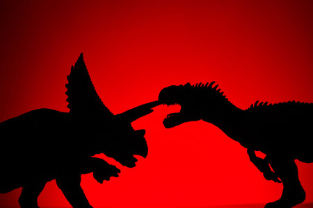shooting dinosaur and monster model on red backgroundの写真素材