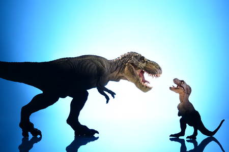 shooting dinosaur model on blue backgroundの写真素材