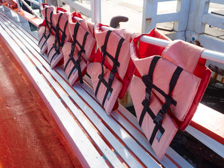 Red life jackets on ferryの写真素材