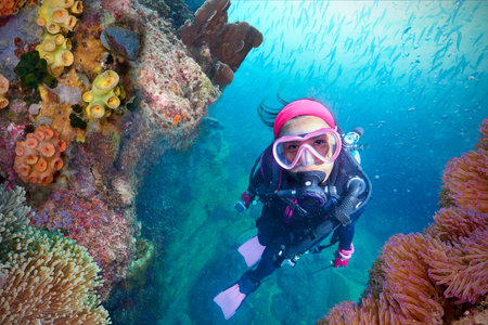 Young Woman Scuba Diver explores a Coral Reef