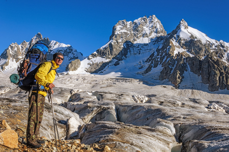 Hiker with a backpack on a glacier in the mountains of Georgiaの写真素材
