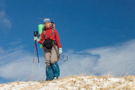 Young woman doing ski touring in winter mountainsの写真素材