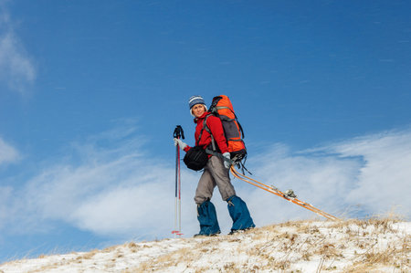 Young woman doing ski touring in winter mountainsの写真素材