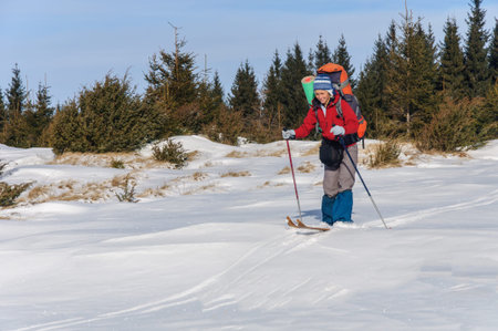 A woman cross country skiing in the mountainの写真素材