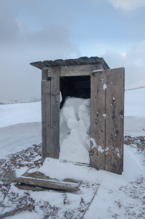 Wooden toilet box  of snow on the alpsの写真素材