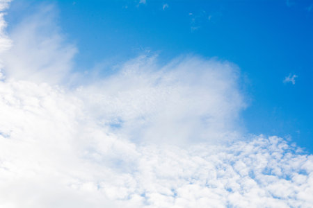 The blue sky background with white clouds
