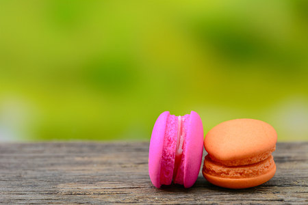 Sweet french macaroons on wooden table with nature backgroundの写真素材
