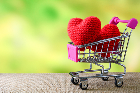 Red heart in shopping cart with nature backgroundの写真素材
