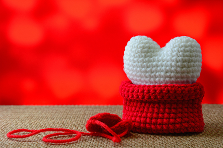 White heart in red bag with red backgroundの写真素材