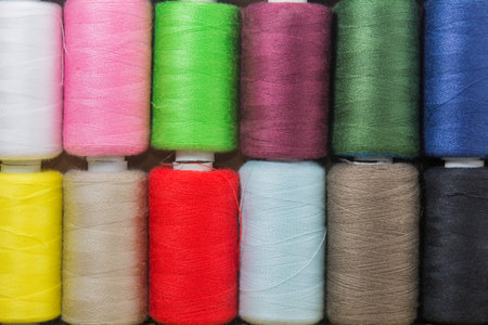 Top view for spools of thread colorful background