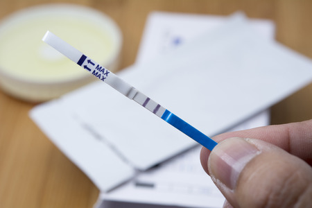 Closeup for Woman holding pregnancy test - Show that pregnantの写真素材