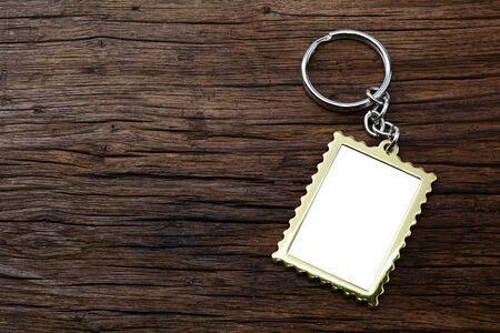 Metal key chain with space for text on wooden backgroundの写真素材